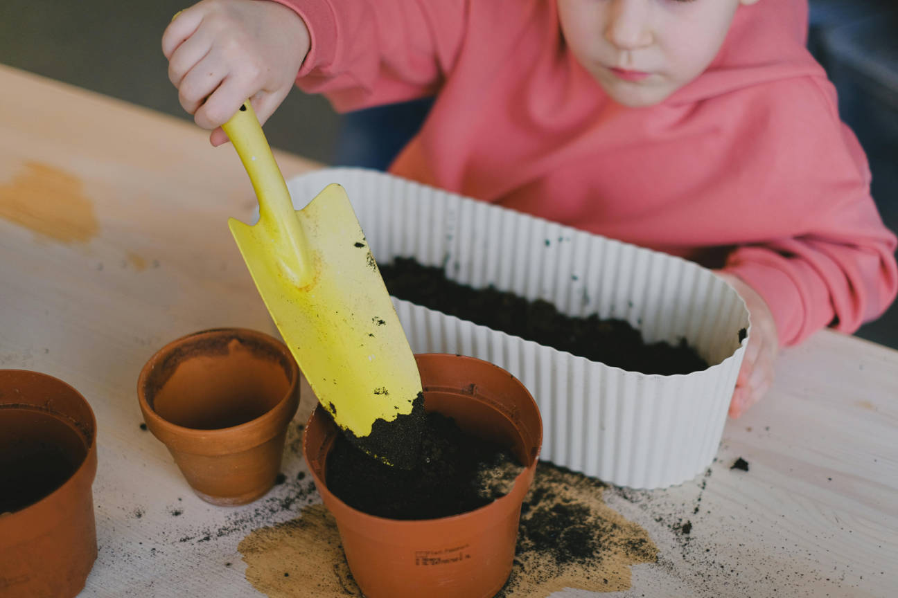 Young gardener with yellow trowel